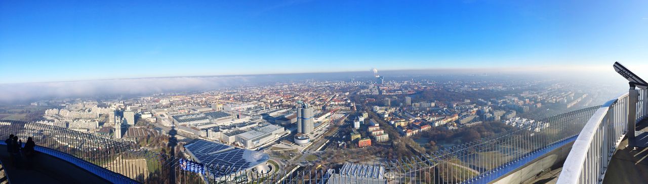 HIGH ANGLE VIEW OF BUILDINGS IN CITY AGAINST BLUE SKY