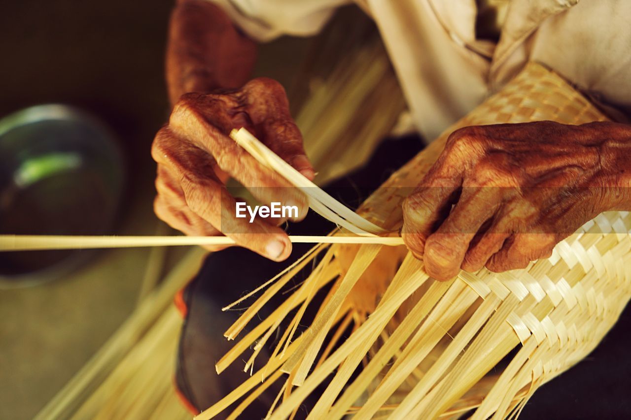 CLOSE-UP OF PERSON PREPARING MEAT