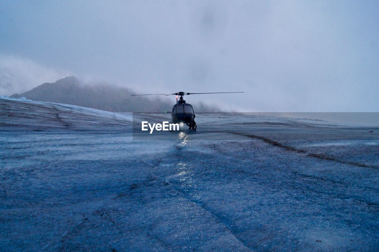 Helicopter atop the mendenhall glacier - ready for take off in the foggy mist.