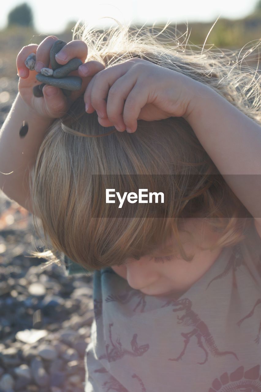 Close-up of girl playing with pebbles