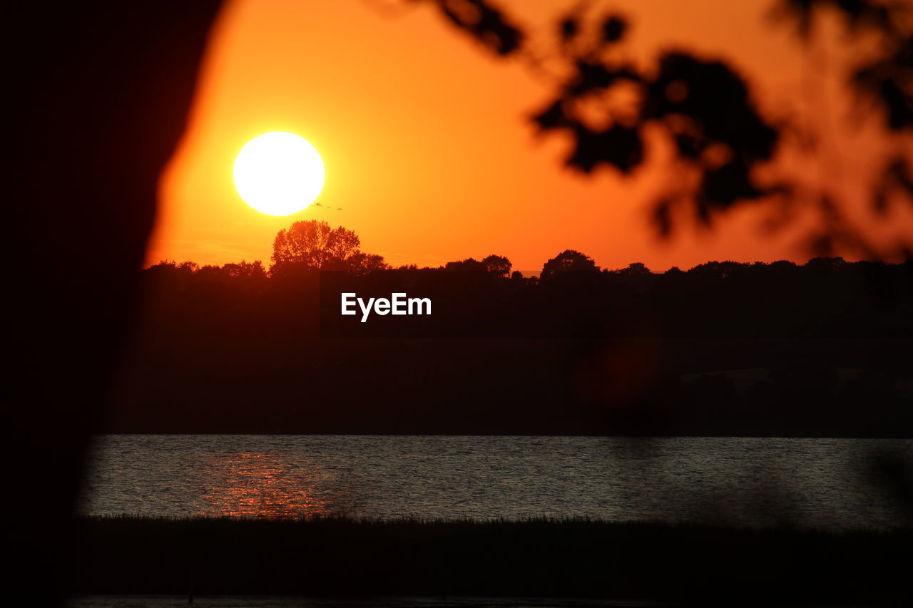 SCENIC VIEW OF SUNSET OVER SEA