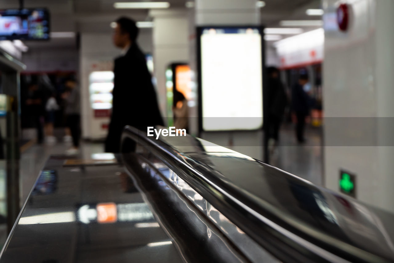 BLURRED MOTION OF MAN WALKING IN SUBWAY