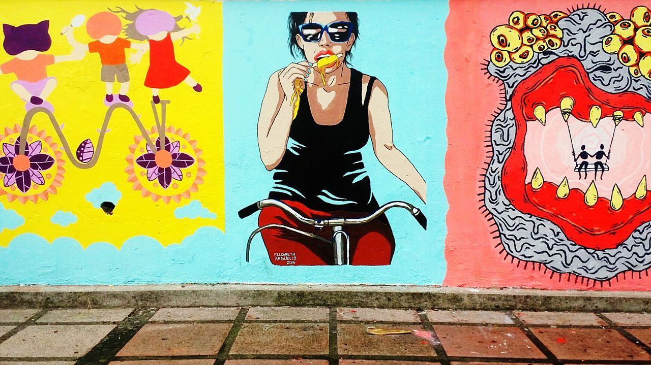 FULL LENGTH OF YOUNG WOMAN WITH MURAL