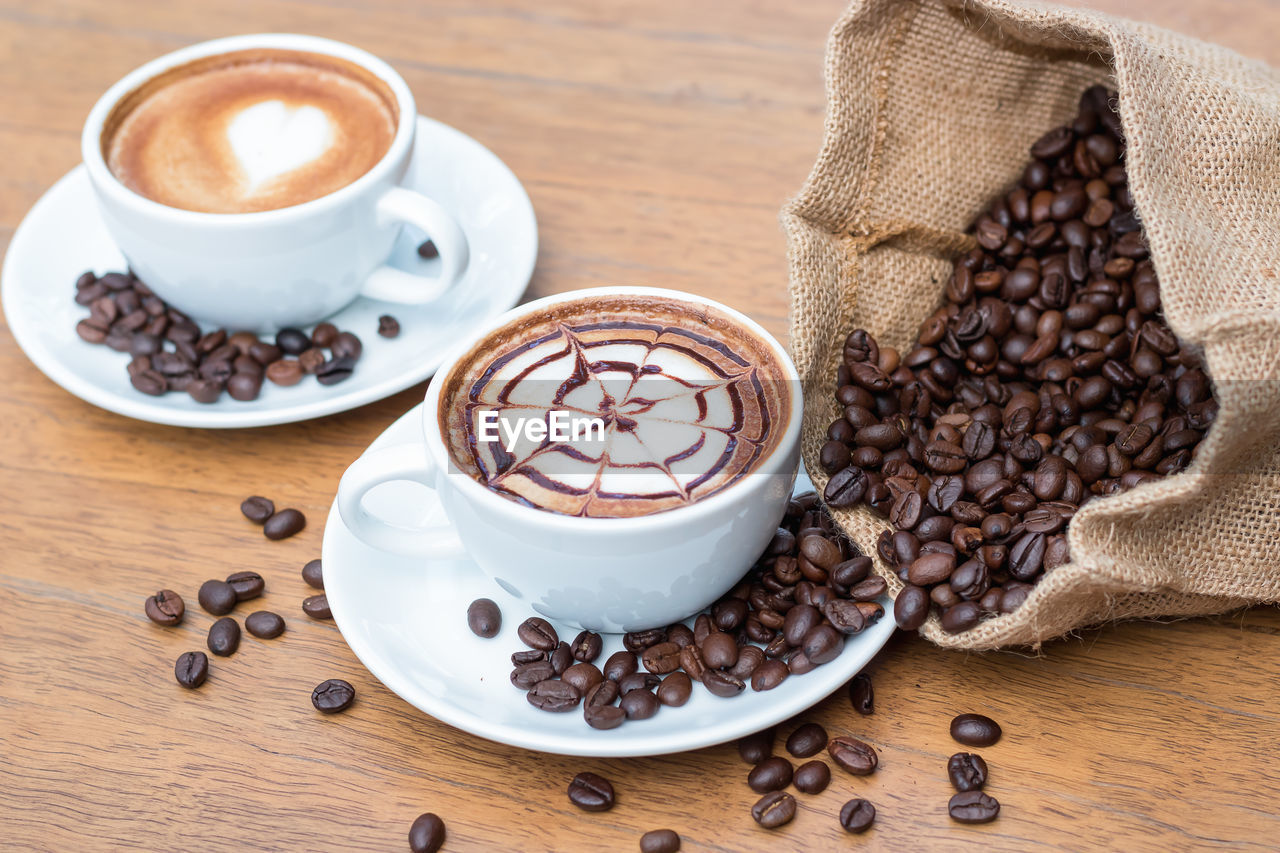 Coffee cup and beans on table