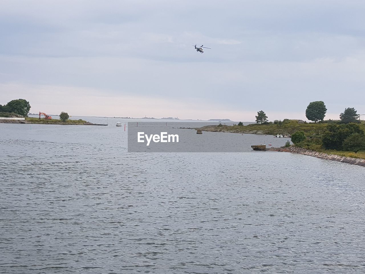 VIEW OF BIRDS FLYING OVER SEA AGAINST SKY