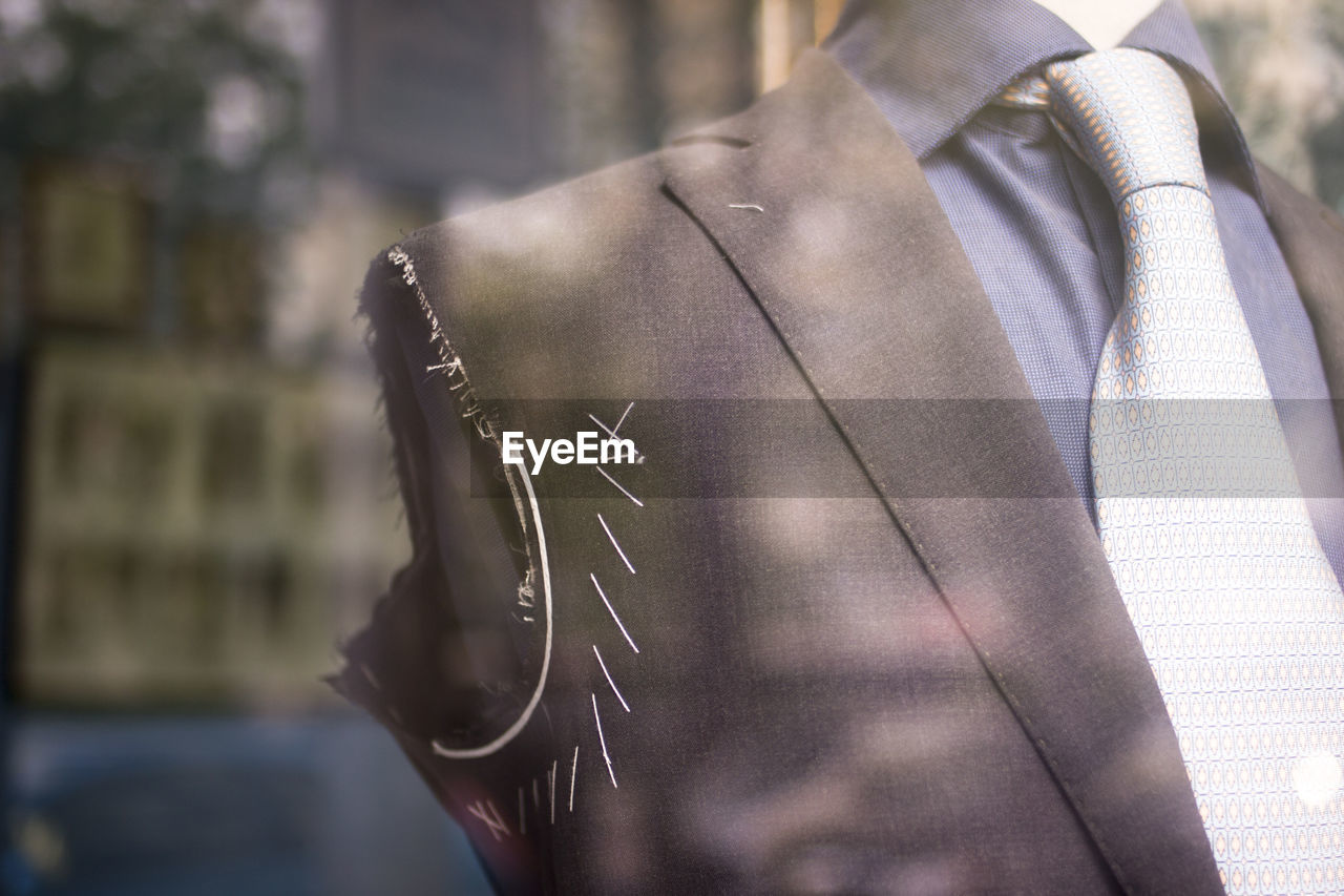 Close-up of suit in mannequin at store for sale