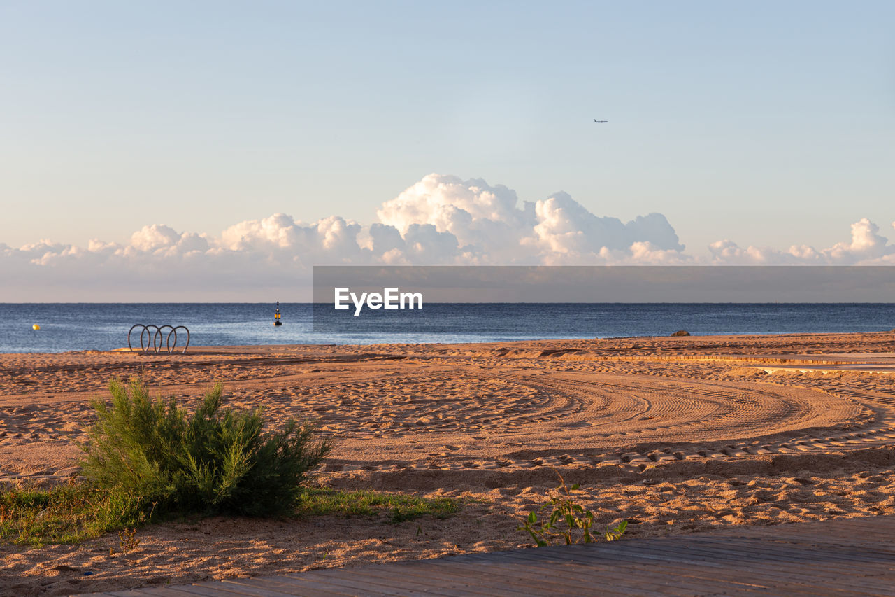 SCENIC VIEW OF BEACH AGAINST SKY DURING SUNRISE