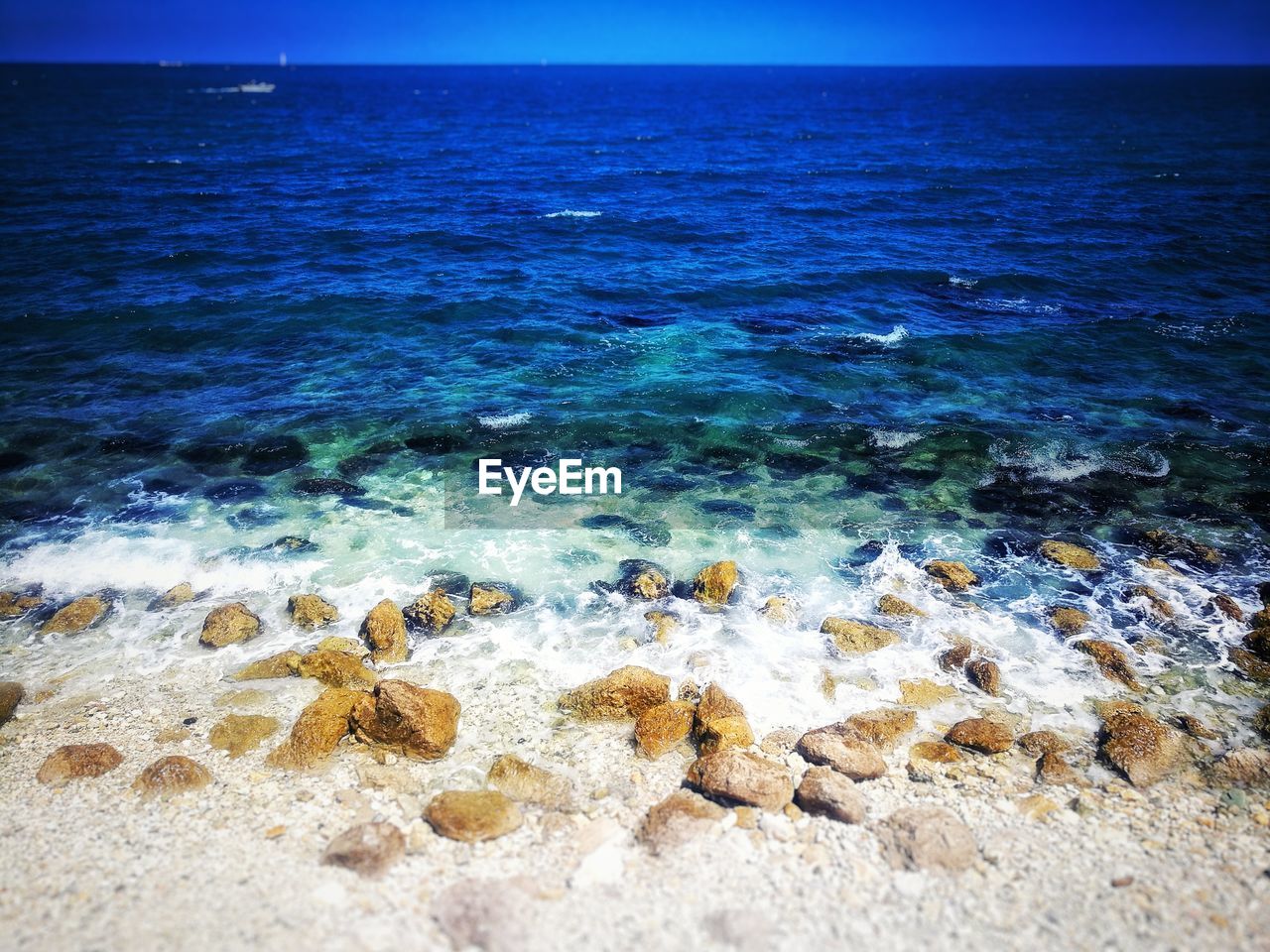 CLOSE-UP OF SEA AGAINST BLUE SKY