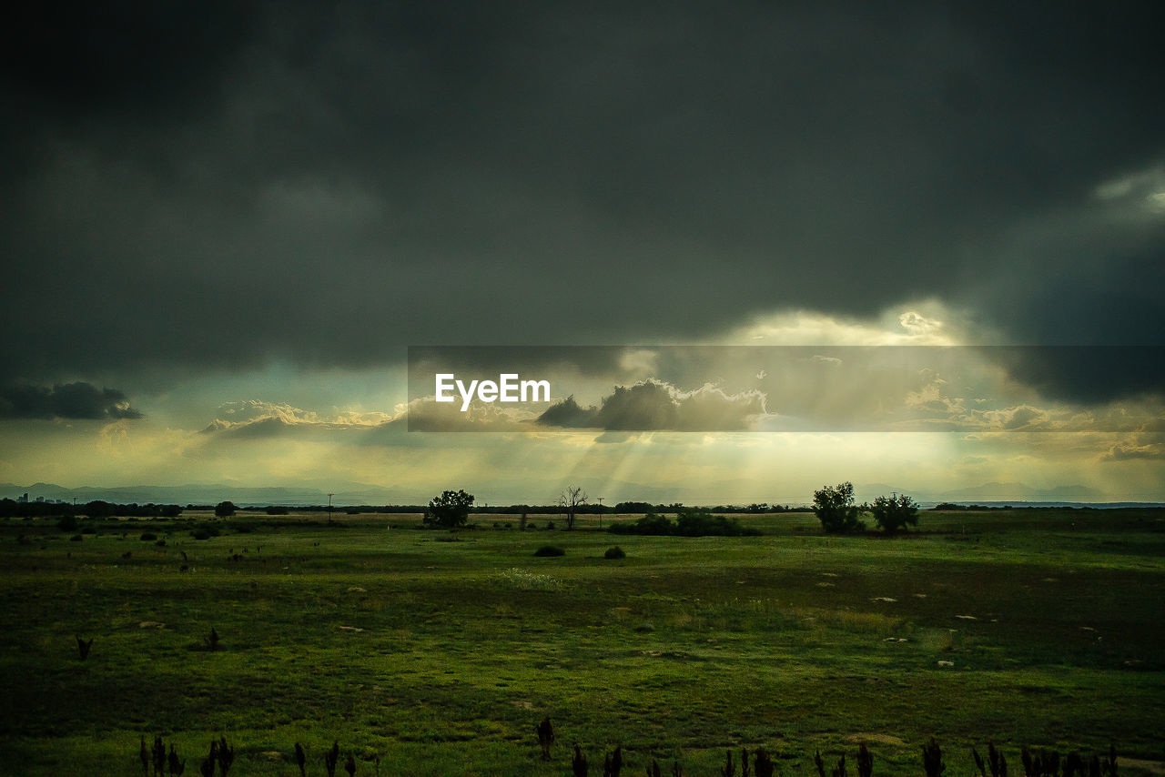 Scenic view of land against cloudy sky