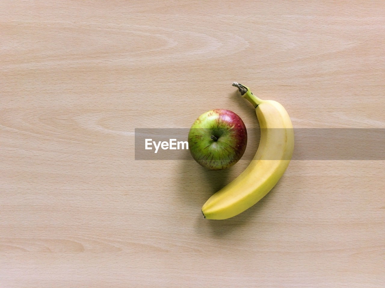 High angle view of apple and banana on table