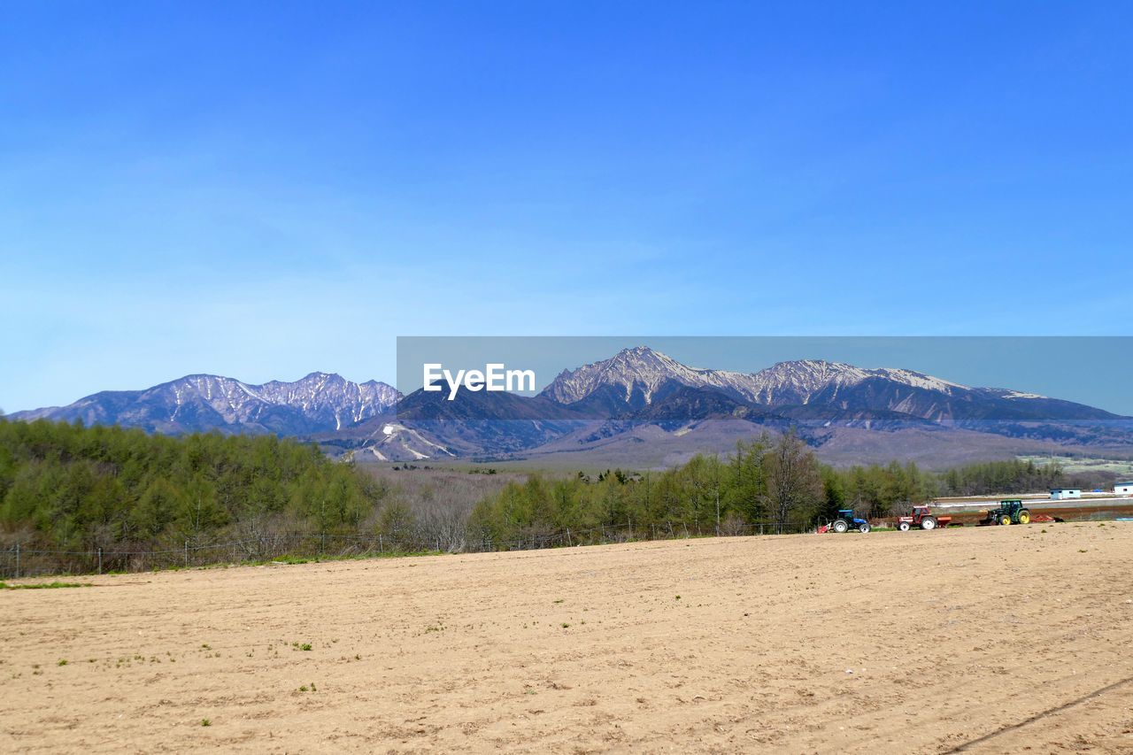 Scenic view of mountains against clear blue sky