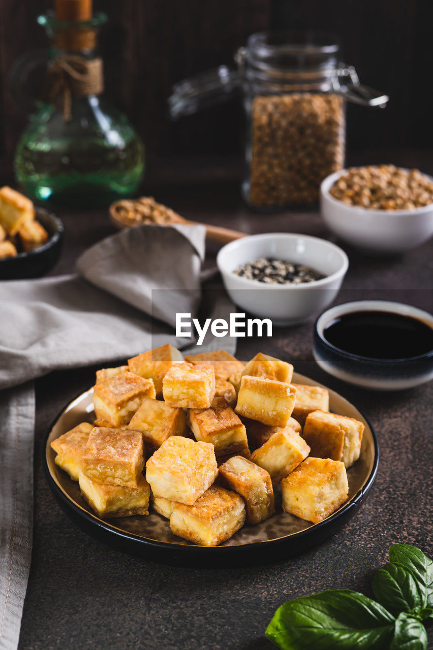 Deep fried vegetarian soy tofu cheese on plate on table vertical view