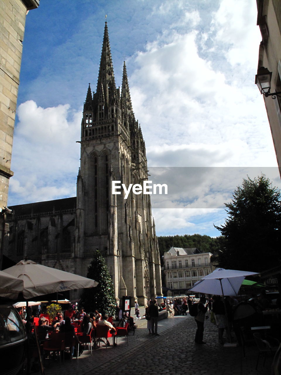 Low angle view of quimper cathedral against cloudy sky in city