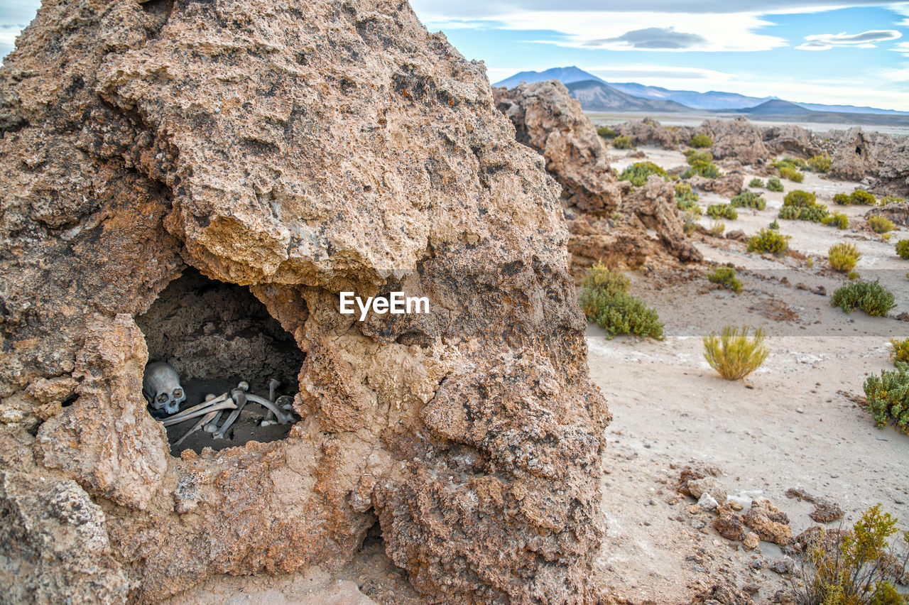 Human bone and skull in rock formation