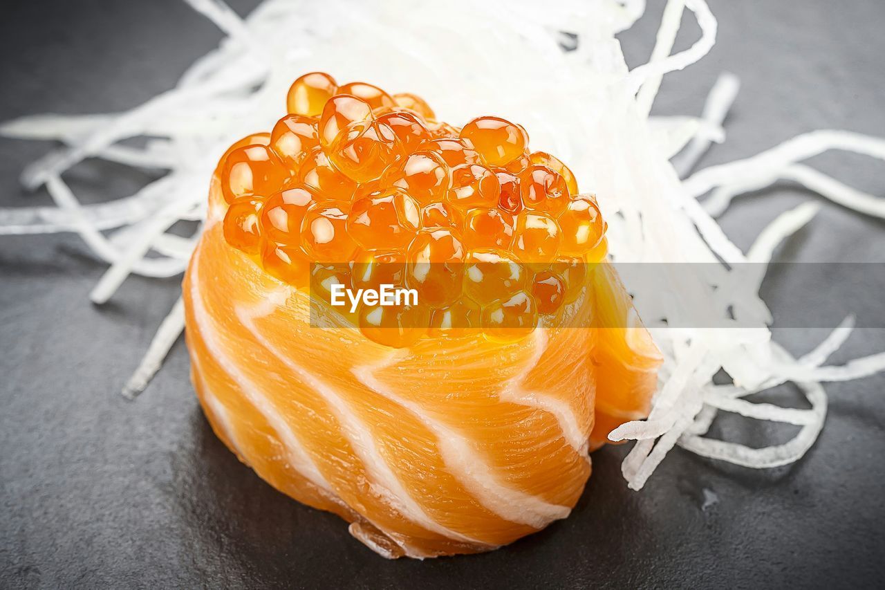Close-up of caviar on wooden plate