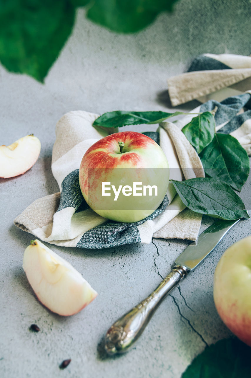 High angel view of freshly harvested ripe green red organic apples over napkin or towel 