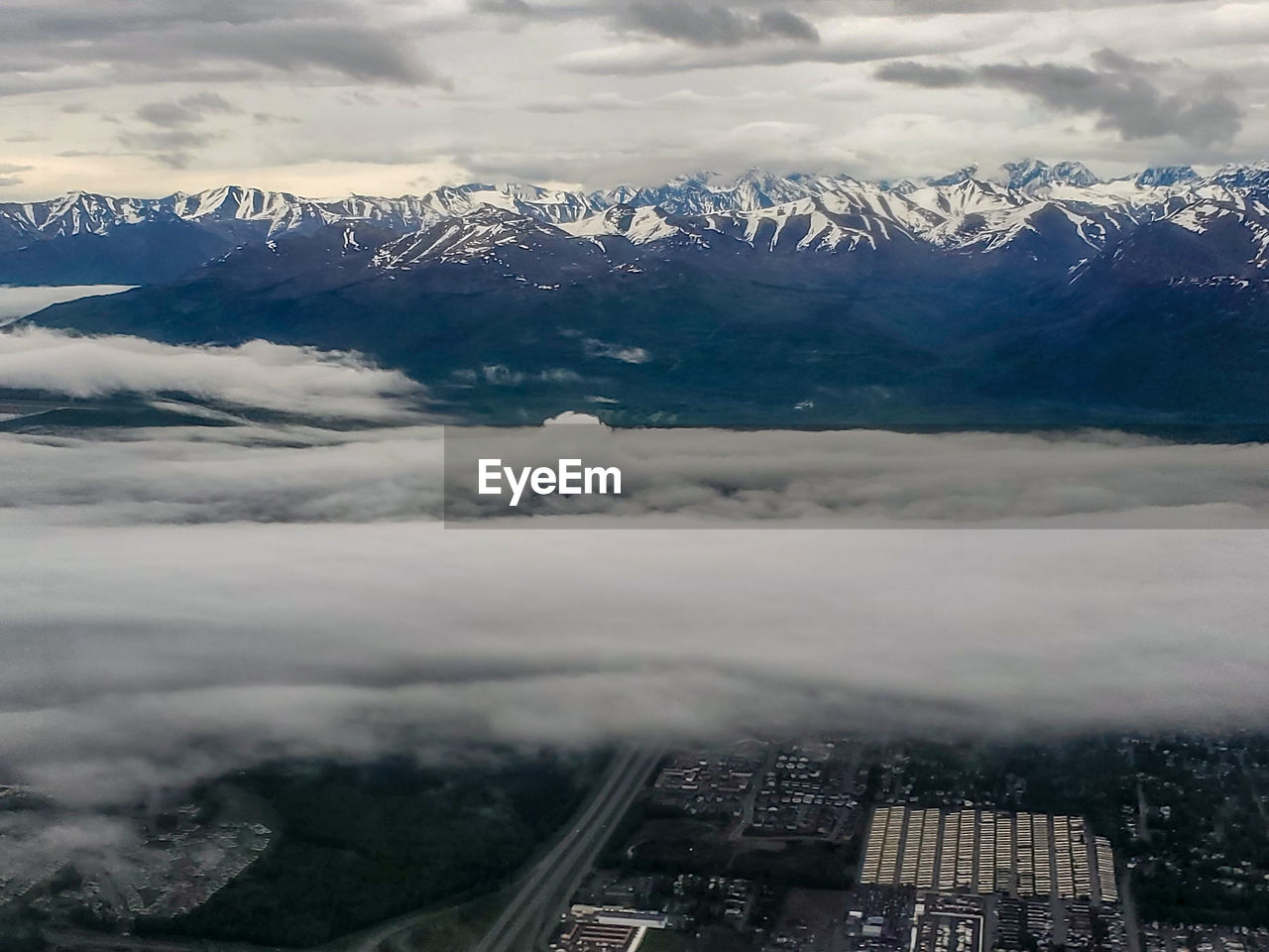 Aerial view of snowcapped mountains against sky