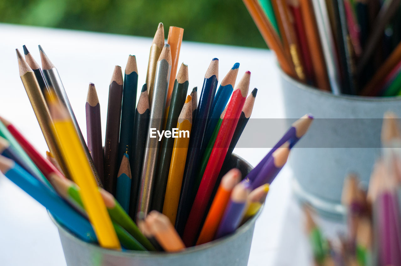 CLOSE-UP OF MULTI COLORED PENCILS IN CONTAINER