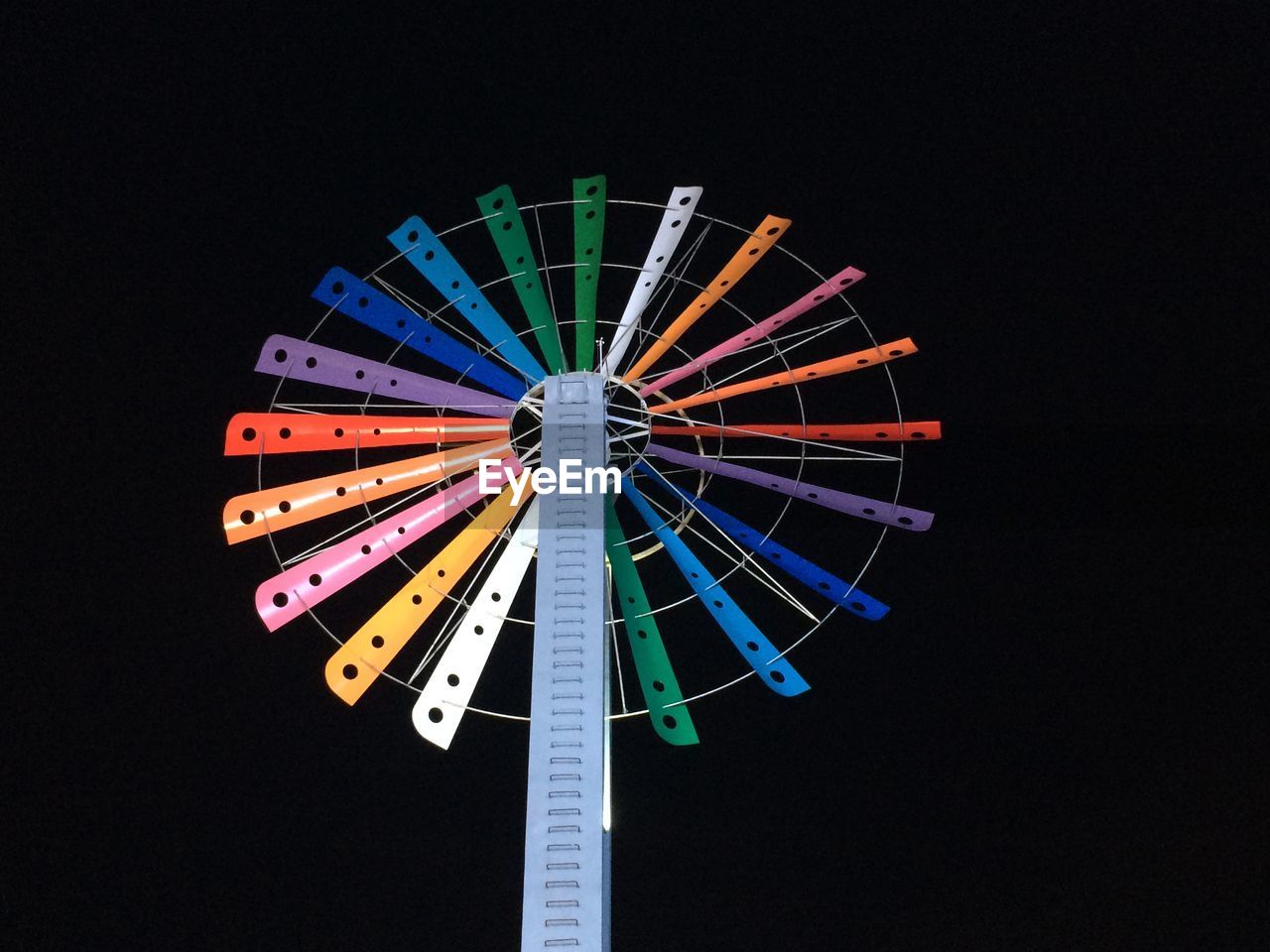 Low angle view of illuminated ferris wheel against sky at night