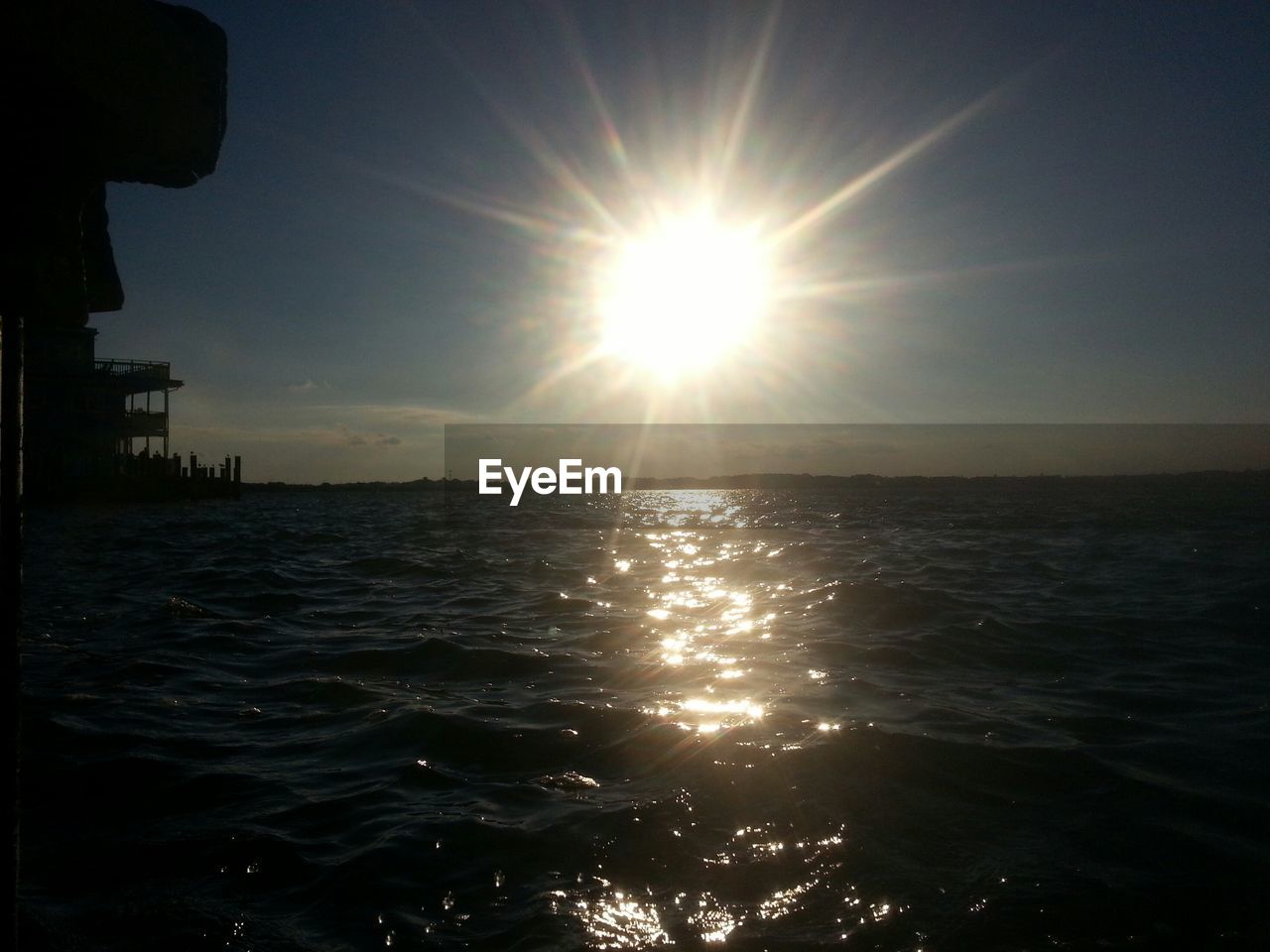 Scenic view of sea against bright sunny day