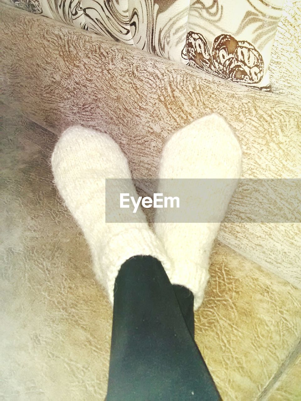 LOW SECTION OF WOMAN STANDING ON CARPET