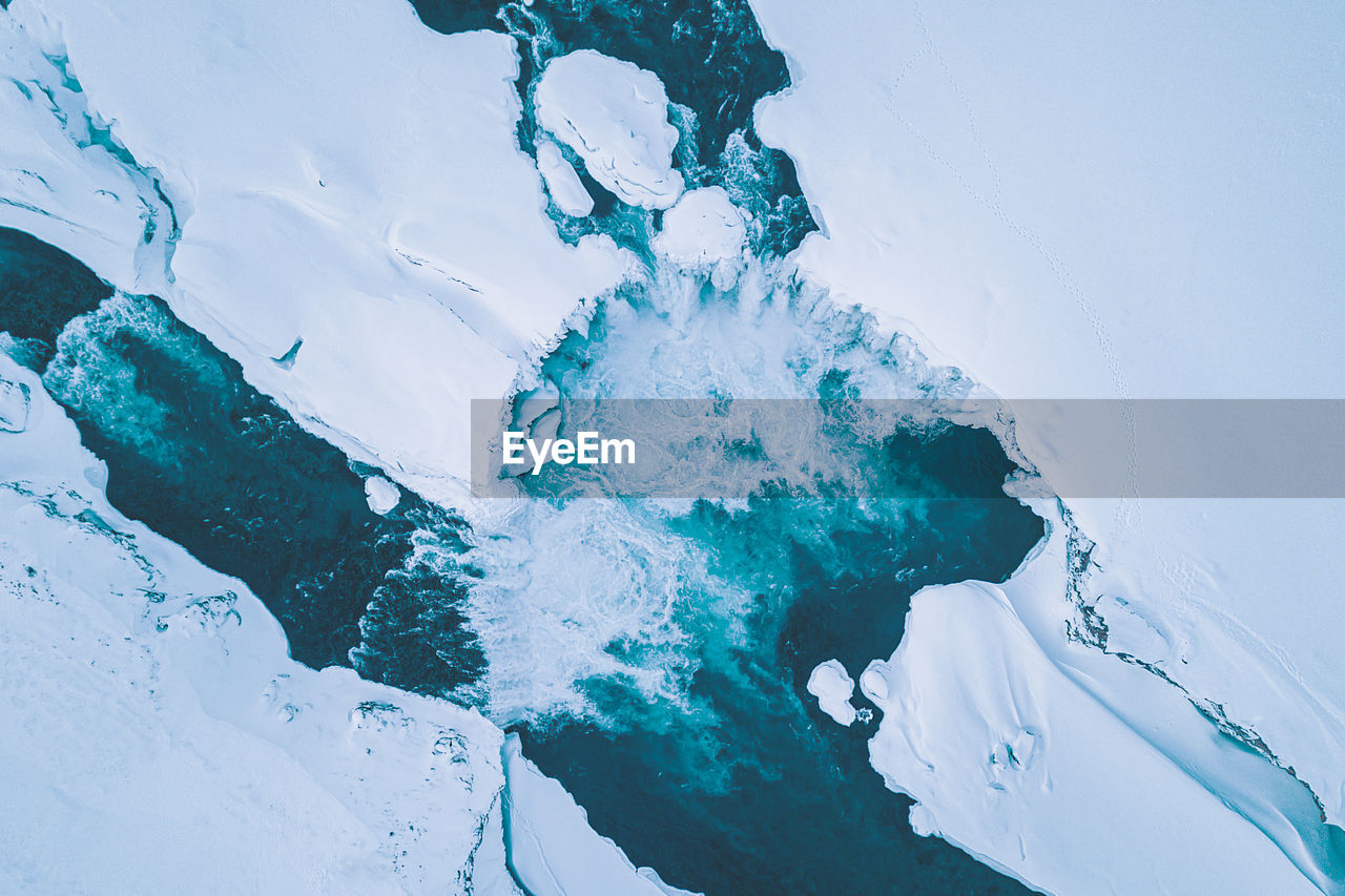 High angle view of frozen land amidst river