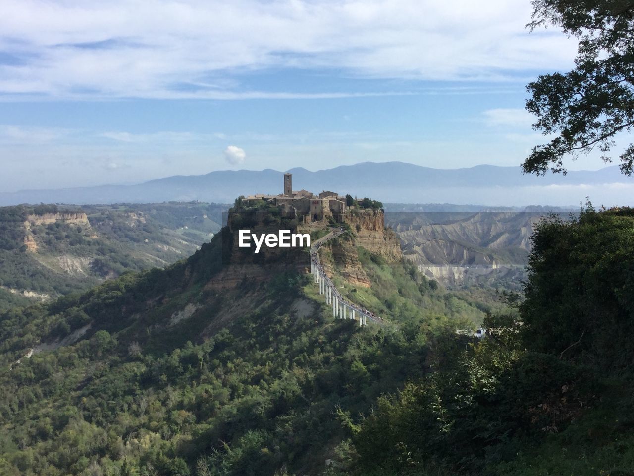 Scenic view of mountains against cloudy sky