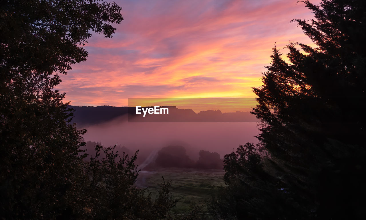 Scenic view of silhouette mountains against sky at sunset