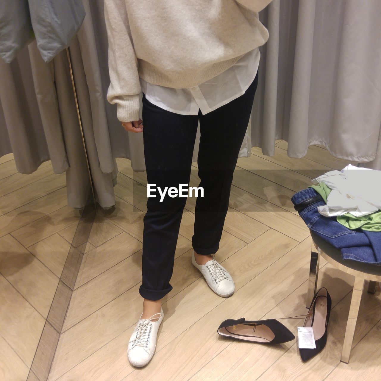 Low section of woman standing in dressing room