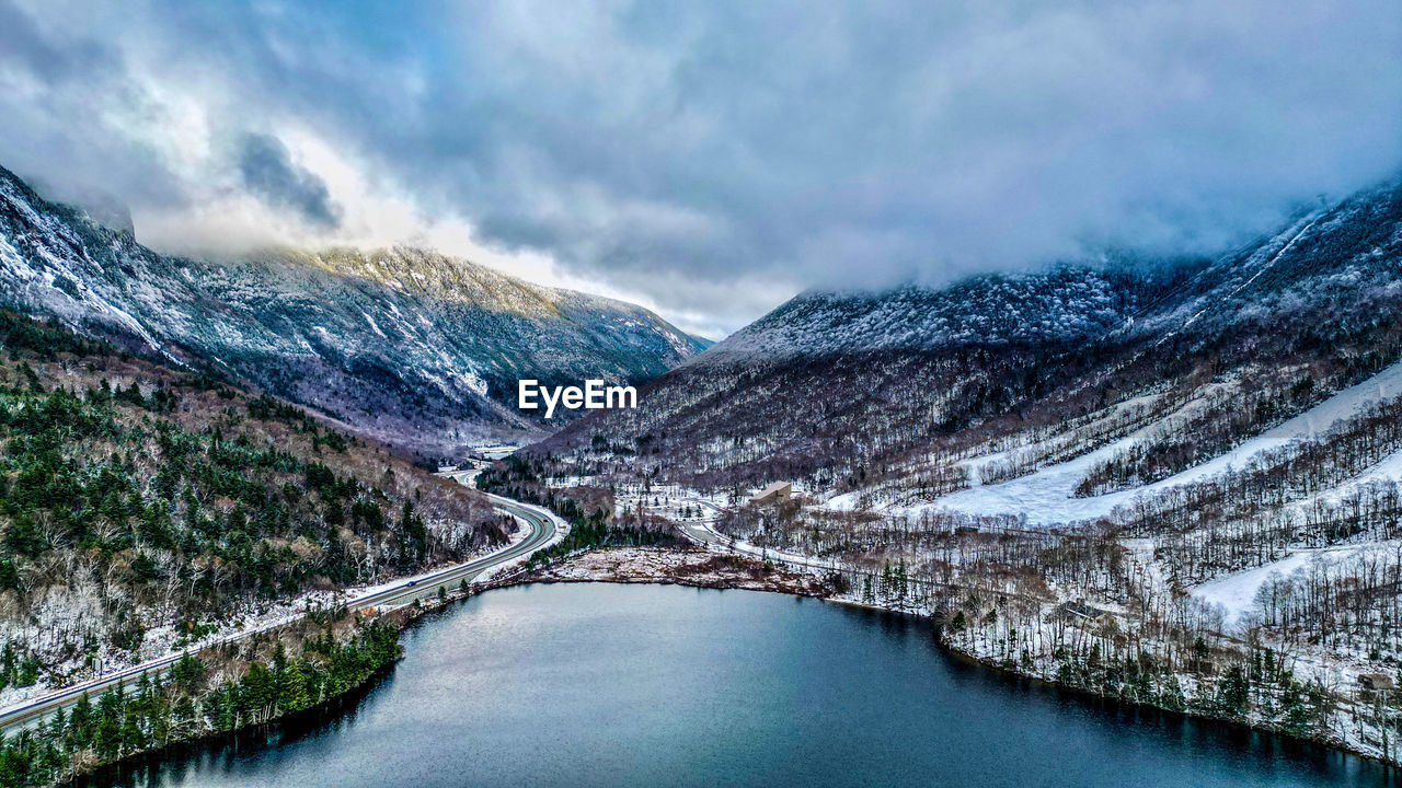 scenic view of lake and snowcapped mountains against sky