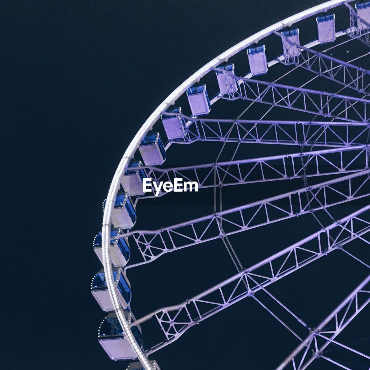 Low angle view of ferris wheel against sky at night