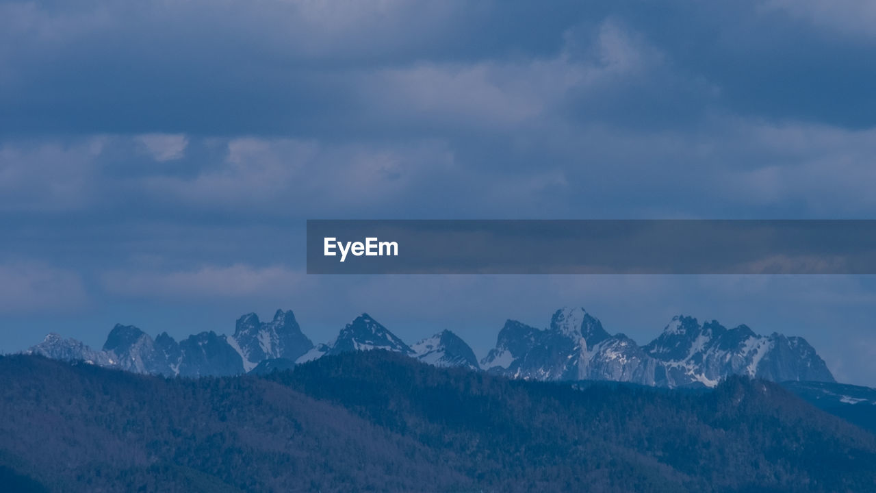 Scenic view of snowcapped mountains against sky