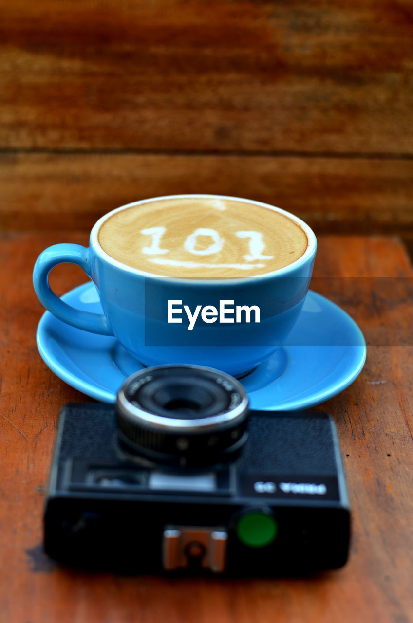 COFFEE CUP ON TABLE WITH SPOON