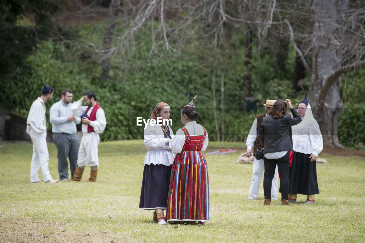 GROUP OF PEOPLE STANDING ON FIELD