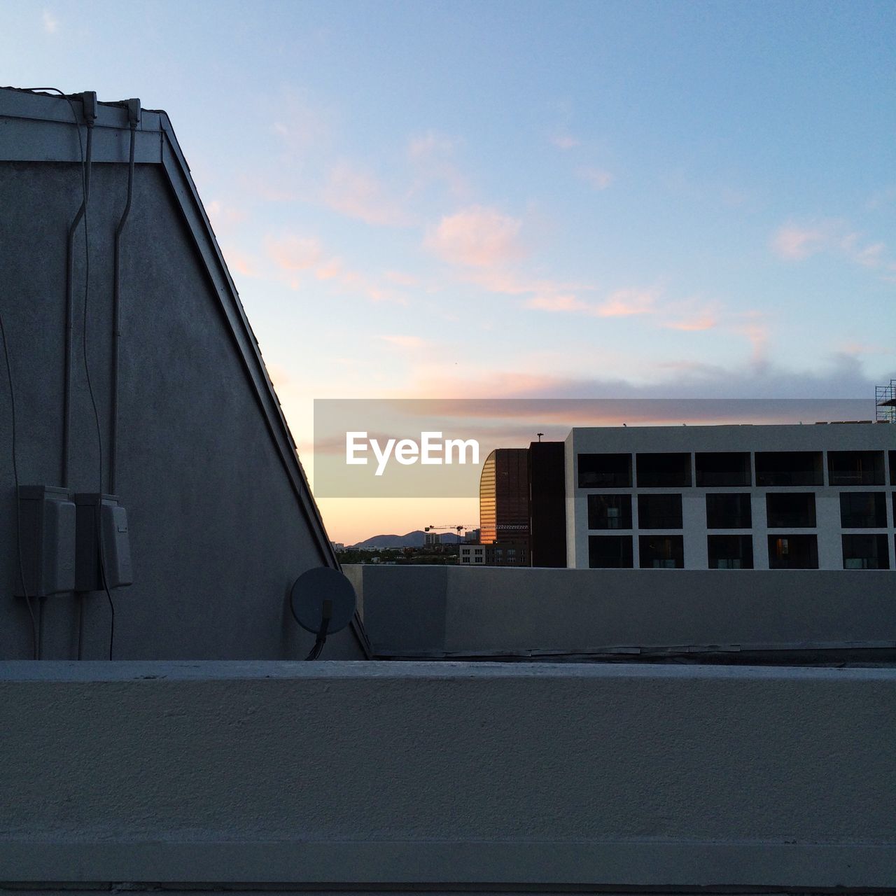 Buildings against sky at sunset