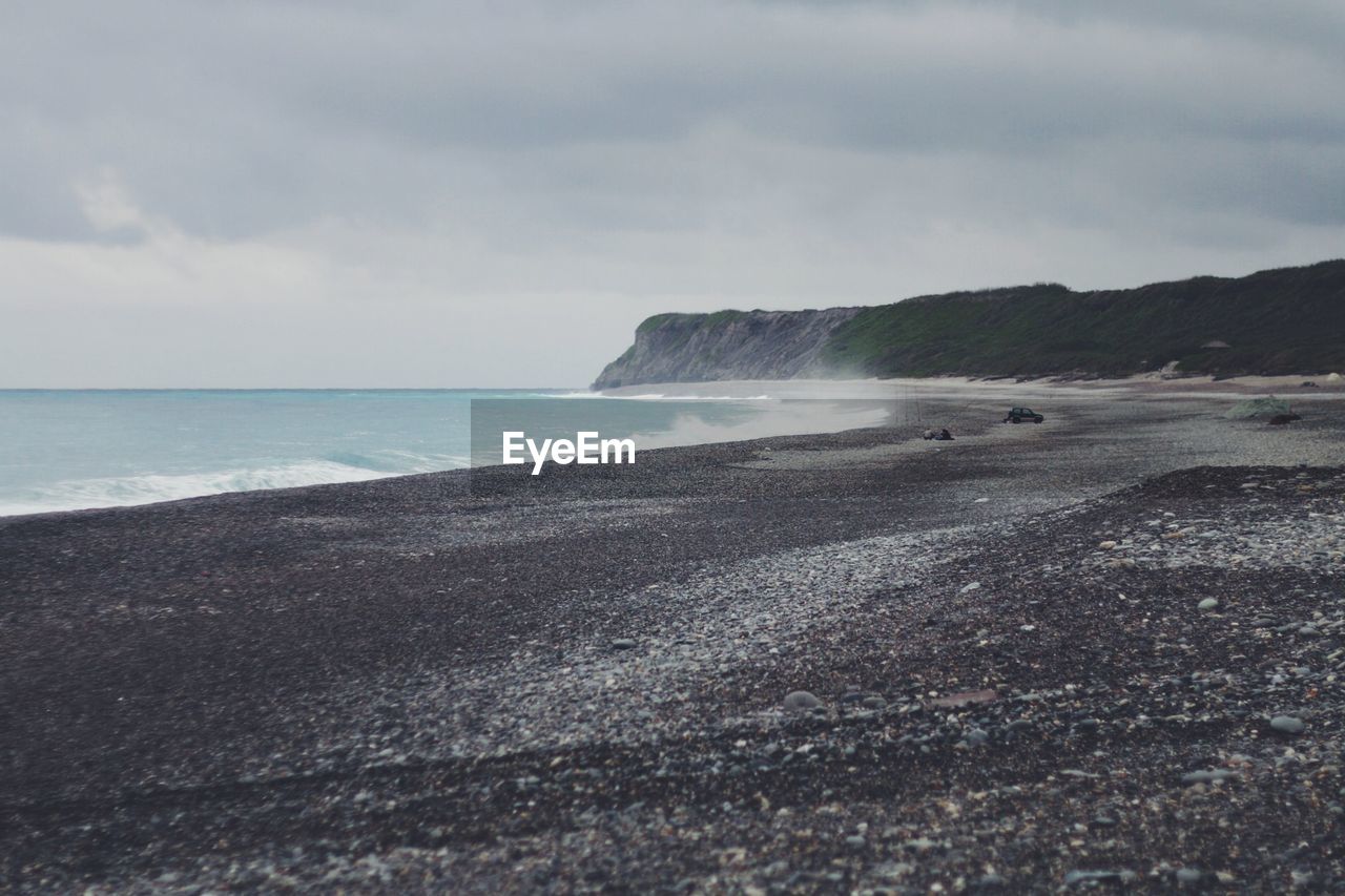 Scenic view of sea against cloudy sky