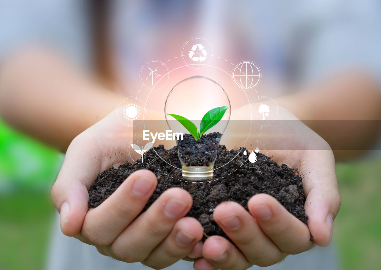 Digital composite image of woman holding dirt and sapling