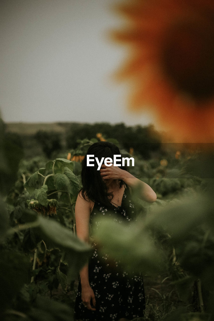 Close-up of woman standing by plants