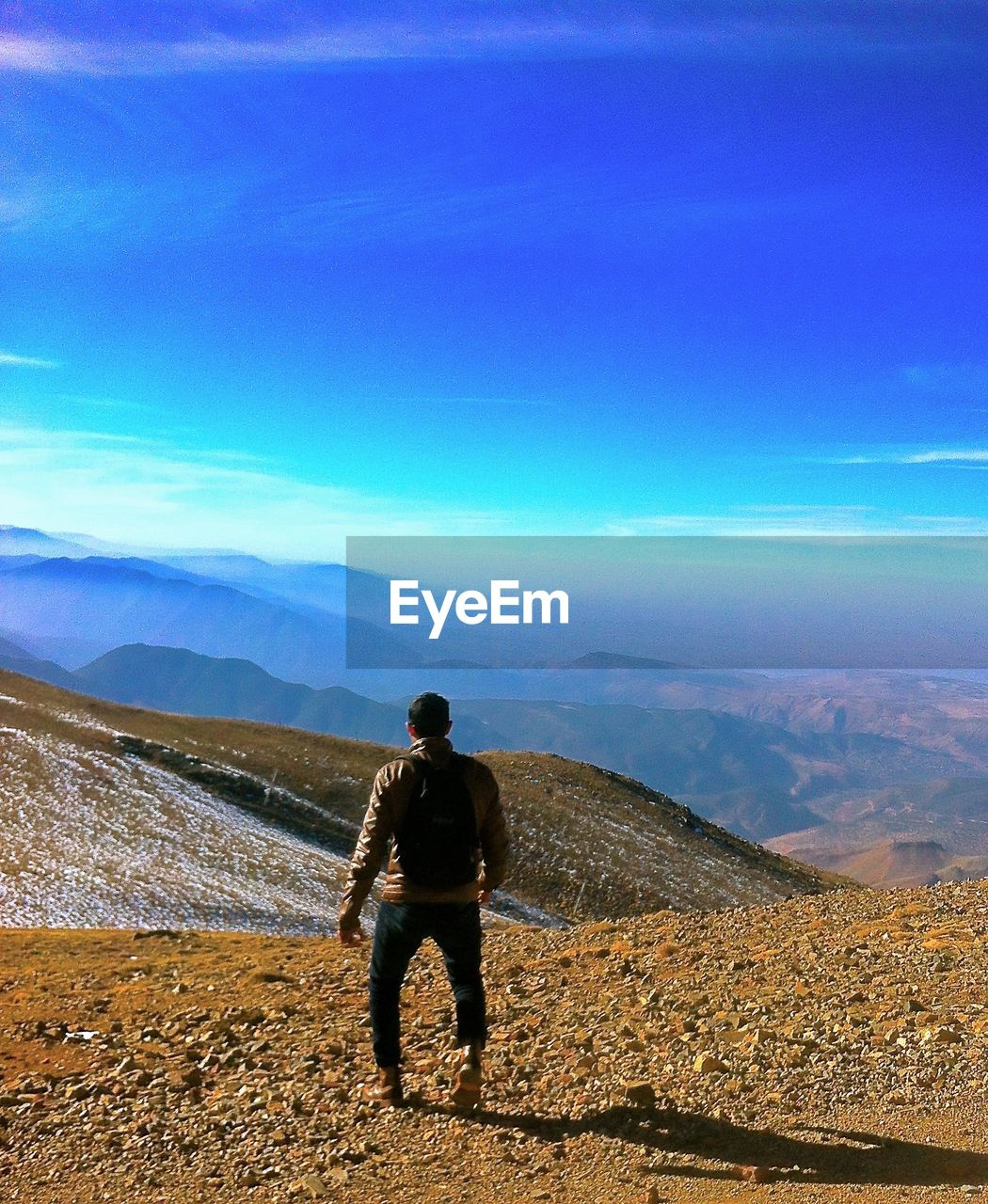 Full length of man standing on mountain against sky