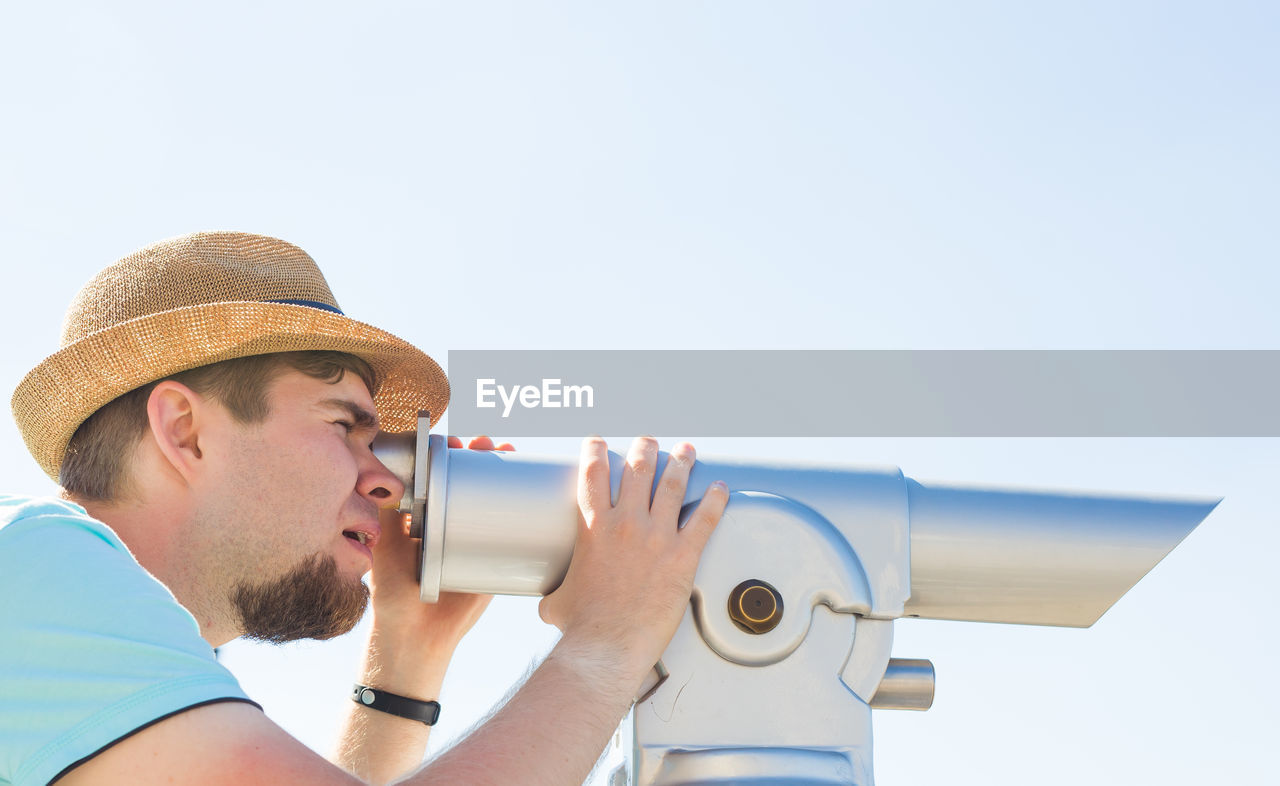 side view of man holding camera