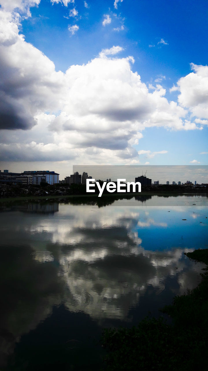 SCENIC VIEW OF LAKE AGAINST CLOUDY SKY