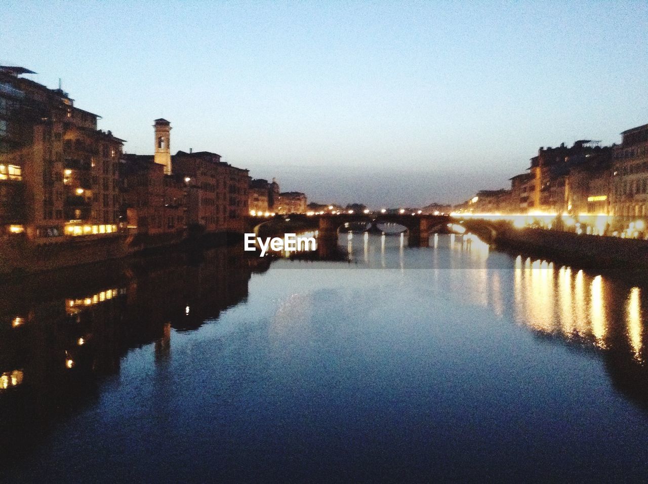 VIEW OF ILLUMINATED BUILDINGS IN RIVER