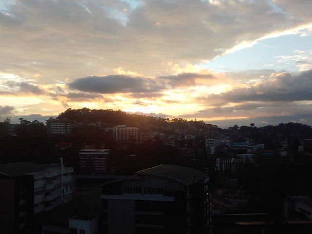 VIEW OF CITYSCAPE AGAINST CLOUDY SKY