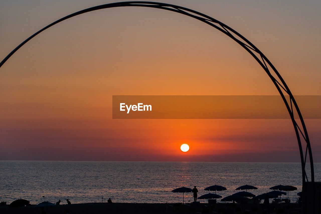 SCENIC VIEW OF SEA AGAINST ORANGE SKY