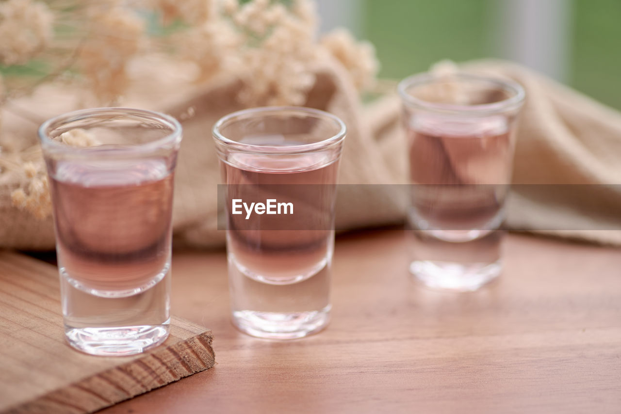 food and drink, glass, drinking glass, drink, household equipment, refreshment, food, table, wood, no people, meal, shot glass, freshness, indoors, water, cold drink, focus on foreground, healthy eating, nature