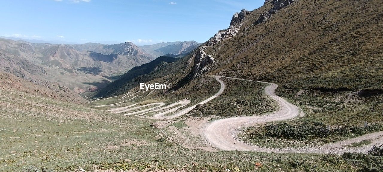 high angle view of road by mountains against sky