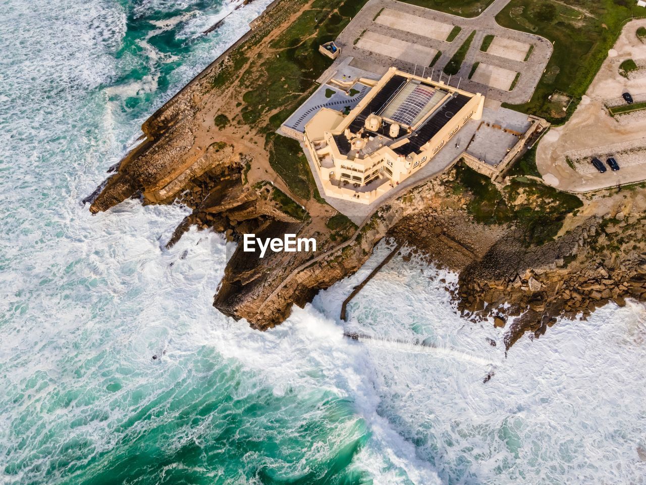 HIGH ANGLE VIEW OF SWIMMING POOL AT SEASIDE