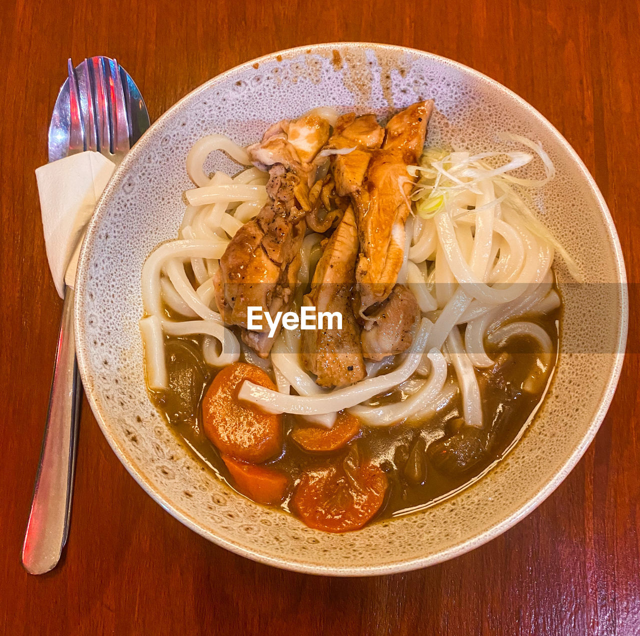 Curry udon with chiken grill . high angle view of food in plate on table