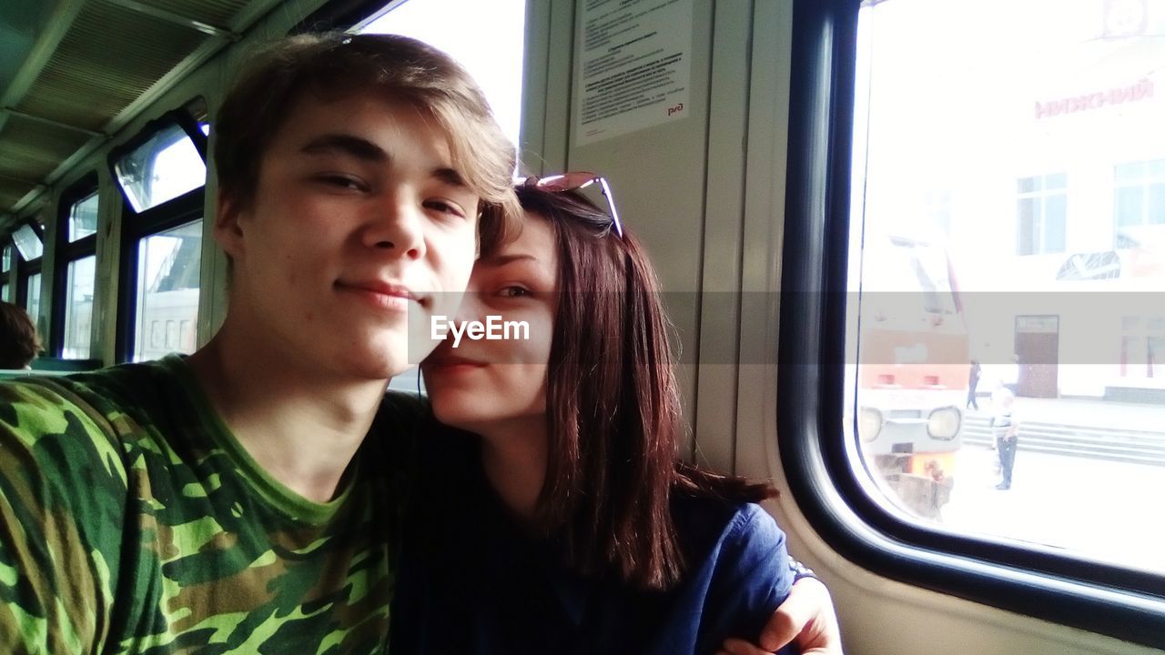 Portrait of couple sitting in train