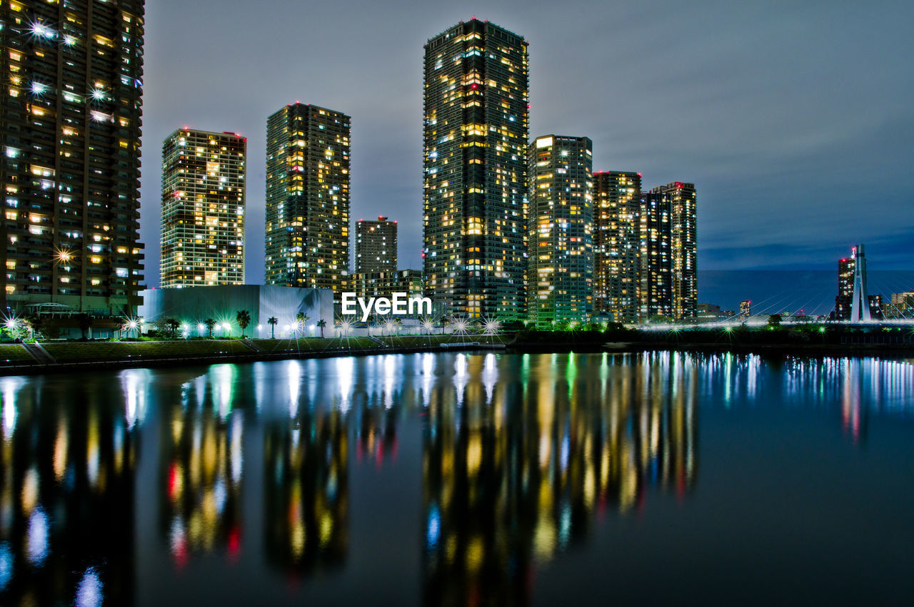 Reflection of illuminated buildings in city at night